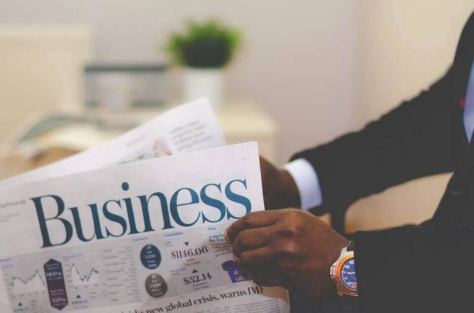 Men holding a newspaper.